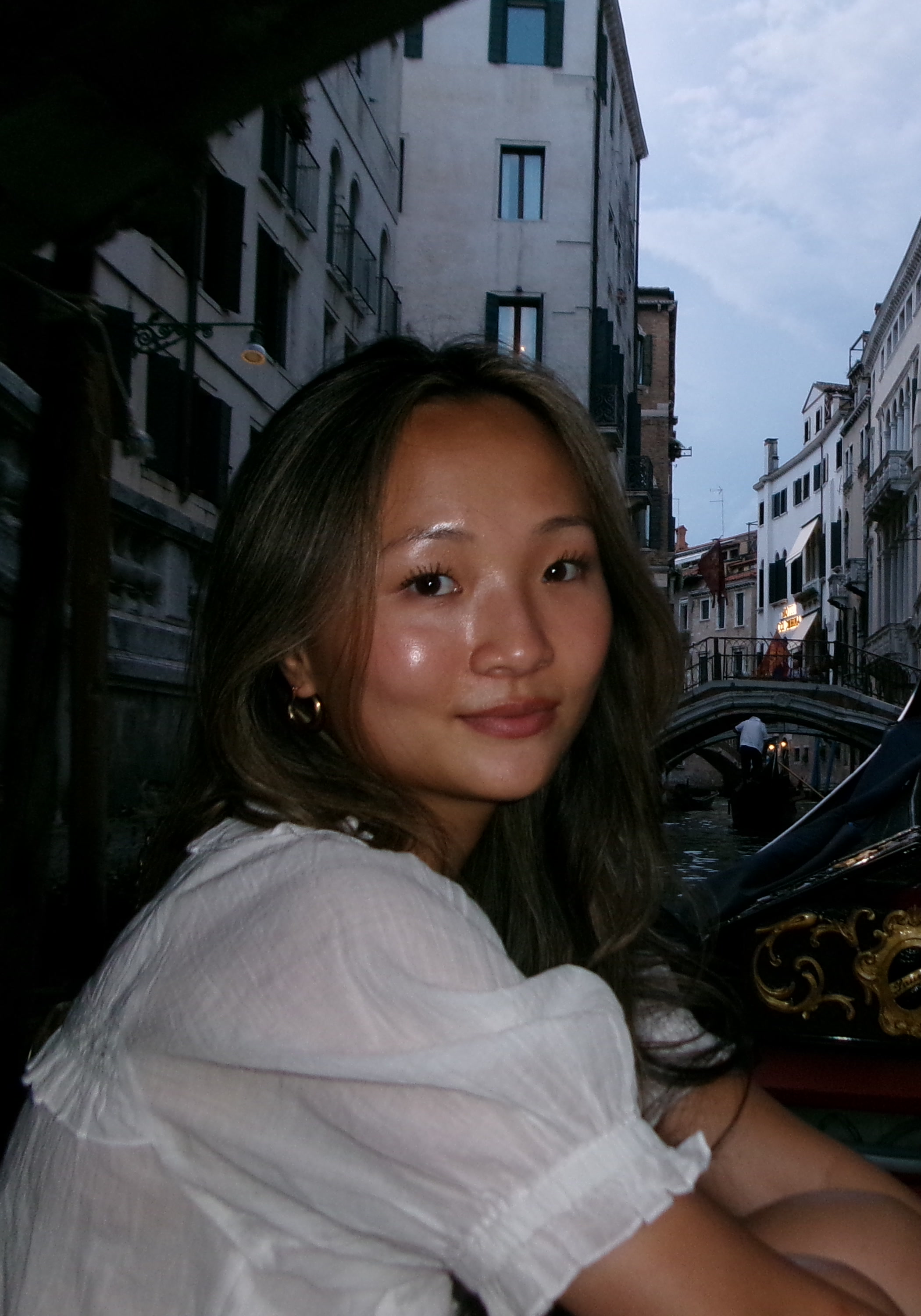 Pannisy sitting in a gondola on a canal in Venice